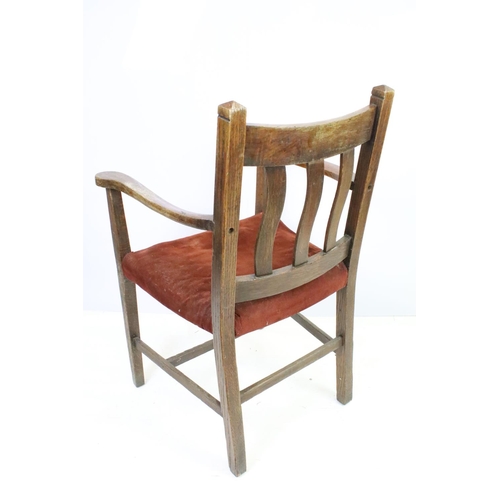 559A - Pair of oak elbow chairs, one with rush seat and another with a corduroy seat, 96cm high x 60cm wide... 