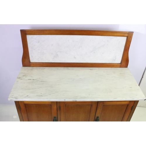 562 - Victorian mahogany washstand, with marble top and marble back above an arrangement of three cupboard... 