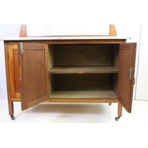 562 - Victorian mahogany washstand, with marble top and marble back above an arrangement of three cupboard... 