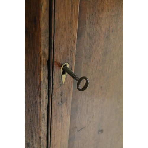 581 - 19th century oak corner cupboard, with double line inlay above panelled door, three fitted shelves t... 