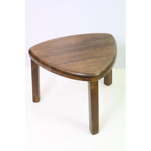 582 - 20th century nest of three oak tables of soft triangle form, the largest 38cm high x 51cm wide x 44c... 