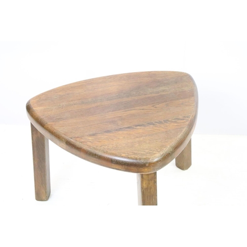 582 - 20th century nest of three oak tables of soft triangle form, the largest 38cm high x 51cm wide x 44c... 