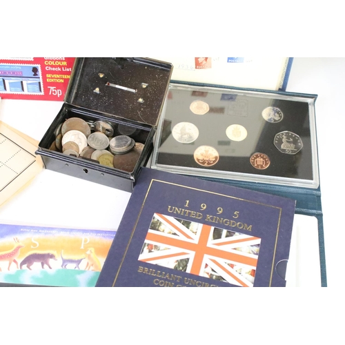 311 - A small collection of mixed stamps together with a selection of coins and cigarette cards.