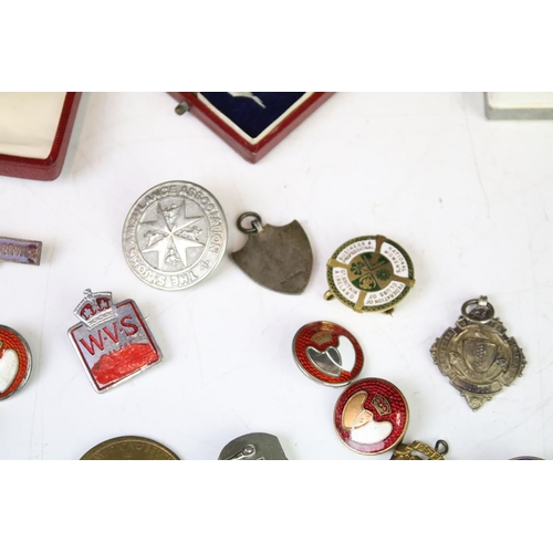 315 - A small group of mixed collectables to include sterling silver watch fobs, medals, badges, penknife ... 