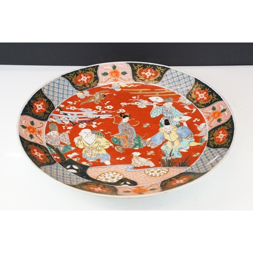 19 - Large Japanese porcelain charger decorated in the Imari palette, decorated with figures, crane and a... 