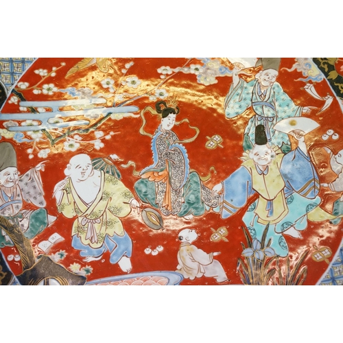 19 - Large Japanese porcelain charger decorated in the Imari palette, decorated with figures, crane and a... 