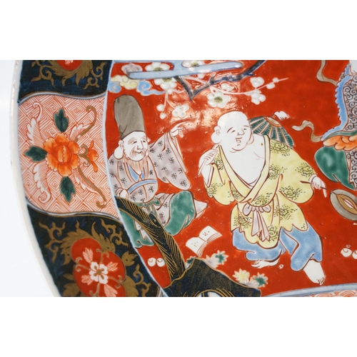 19 - Large Japanese porcelain charger decorated in the Imari palette, decorated with figures, crane and a... 