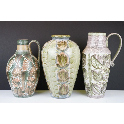 32 - Three Denby stoneware jugs / vases with foliate & mottled decoration, one signed 'Glyn Colledge' to ... 