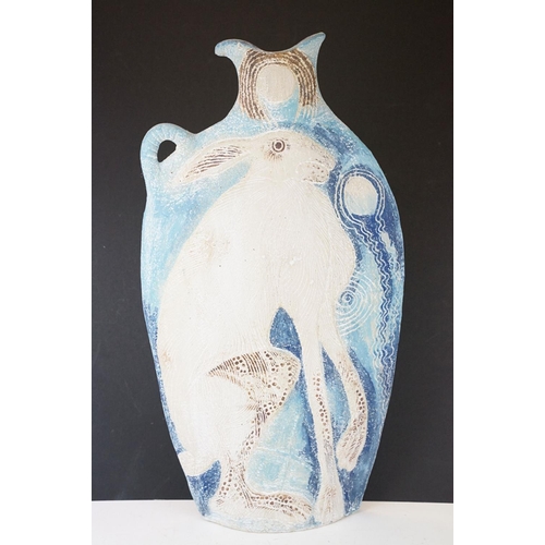 34 - Michelle Cowmeadow studio pottery hare slab vase on blue ground, with single handle, initialled to b... 