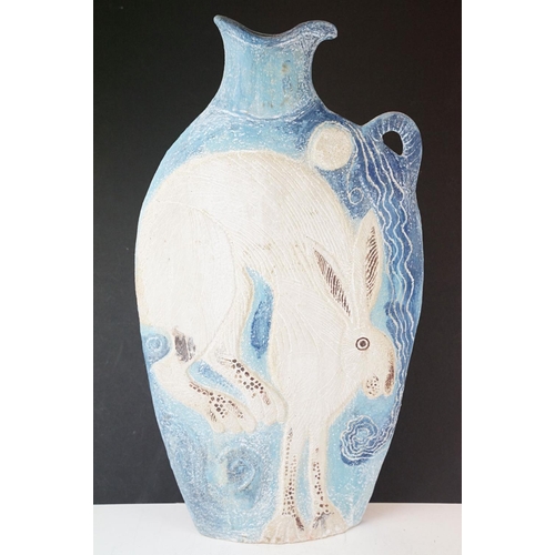 34 - Michelle Cowmeadow studio pottery hare slab vase on blue ground, with single handle, initialled to b... 