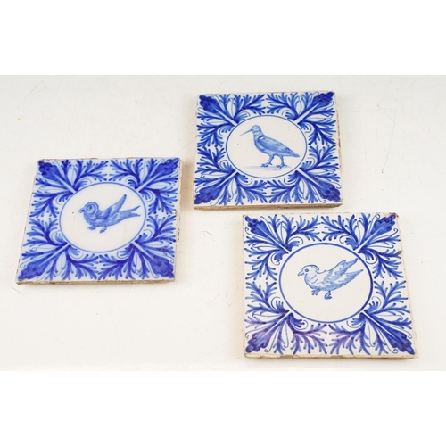 54 - Three blue & white tiles with central panels depicting birds, bordered by foliate detail, measure ap... 