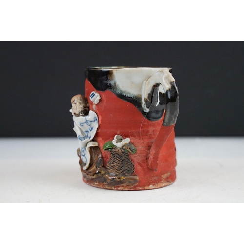 57 - Japanese Sumida Gawa pottery mug / tankard, with relief decoration of a figure, signed Ryosai, appro... 