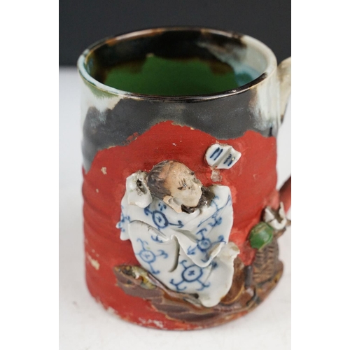 57 - Japanese Sumida Gawa pottery mug / tankard, with relief decoration of a figure, signed Ryosai, appro... 