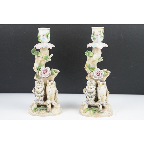 58 - Pair of continental porcelain candlesticks with owl and floral encrusted decoration, blue anchor mar... 