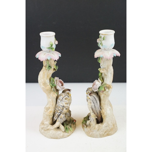 58 - Pair of continental porcelain candlesticks with owl and floral encrusted decoration, blue anchor mar... 