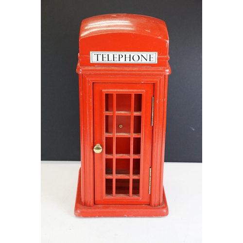 171 - Holdcourt Ltd of London - A painted wooden model of a telephone box, makers label to reverse. Measur... 