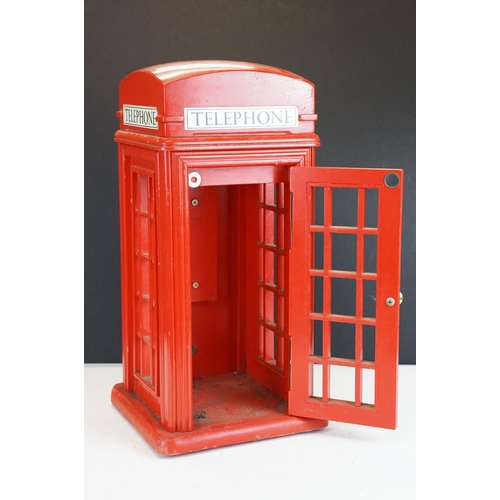 171 - Holdcourt Ltd of London - A painted wooden model of a telephone box, makers label to reverse. Measur... 