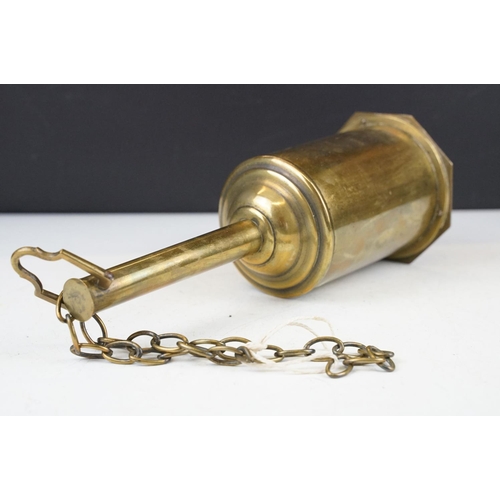 375 - A vintage brass preserve pan together with a clockwork and cast iron meat hanger.