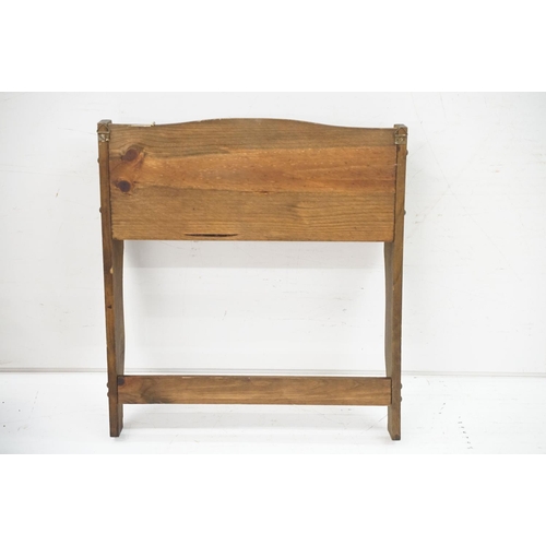 379 - A hanging shelf with peg hooks plus a small four legged stool.