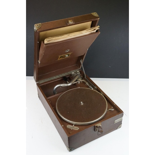 383 - A vintage HMV portable wind up record player together with a quantity of records.