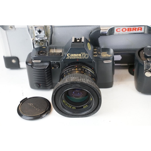 384 - A collection of Canon photographic equipment to include two Canon T70 SLR cameras, lenses, Flashes .... 
