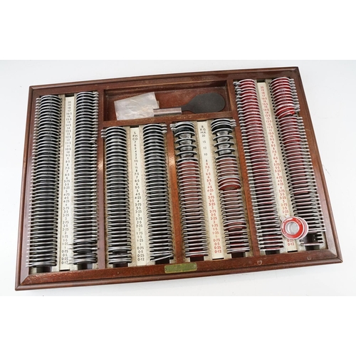 392 - A vintage opticians eye testing kits within wooden cases.