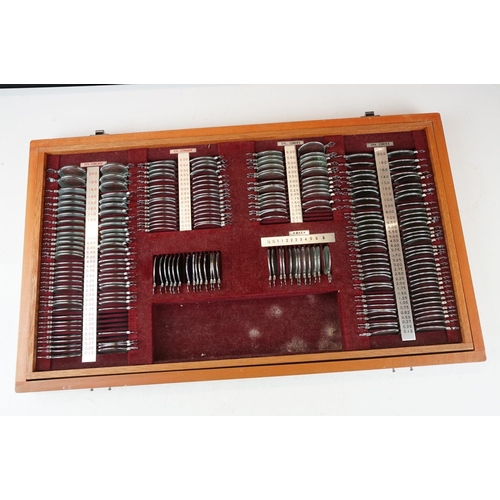 392 - A vintage opticians eye testing kits within wooden cases.