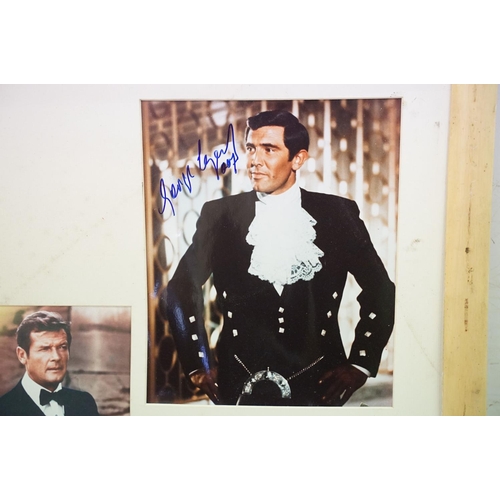 399 - Set of five James Bond photographs, signed, 56 x 60cm overall, James Bond 007 poster, gun symbol log... 