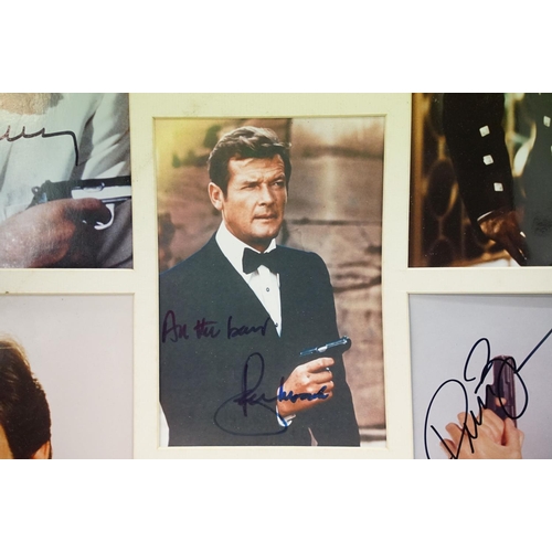 399 - Set of five James Bond photographs, signed, 56 x 60cm overall, James Bond 007 poster, gun symbol log... 