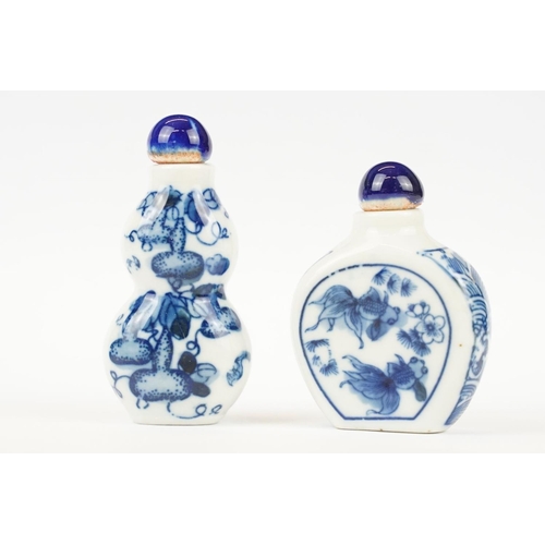 49 - Two Chinese blue and white ceramic snuff bottles with traditional Chinese decoration.