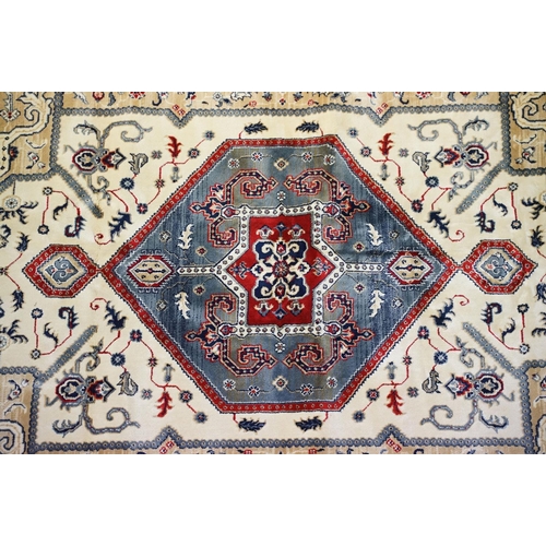 574 - Ivory ground Kashmir floor rug with Aztec medallion design, approx 180cm long x 116cm wide