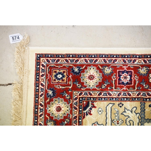 574 - Ivory ground Kashmir floor rug with Aztec medallion design, approx 180cm long x 116cm wide