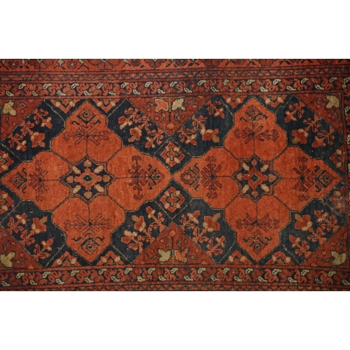 575 - Middle Eastern carpet with two central medallions, red and black ground within geometric borders, 16... 