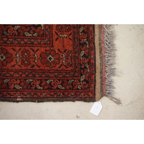 575 - Middle Eastern carpet with two central medallions, red and black ground within geometric borders, 16... 