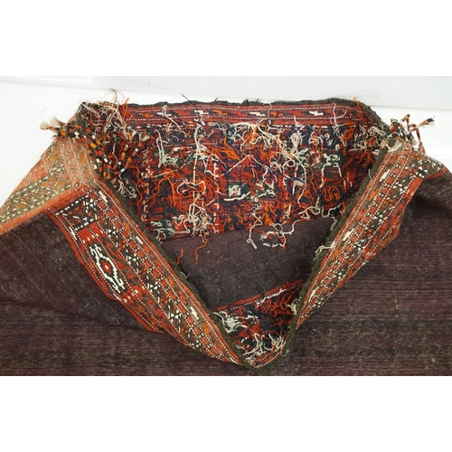 588 - Pair of large Afghan woven carpet saddle bags each with geometric detailing and woven tassels. Measu... 