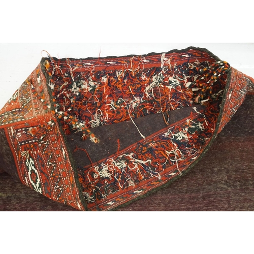 588 - Pair of large Afghan woven carpet saddle bags each with geometric detailing and woven tassels. Measu... 