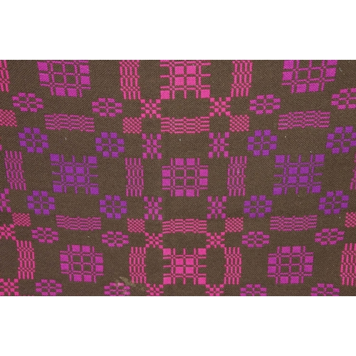 415 - Welsh woollen blanket, of arch shaped form, geometric pink and purple designs on a brown ground, wit... 