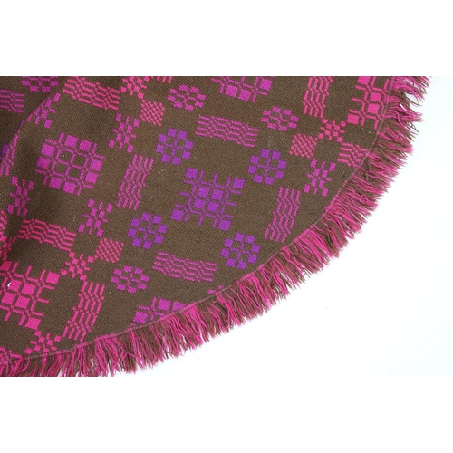 415 - Welsh woollen blanket, of arch shaped form, geometric pink and purple designs on a brown ground, wit... 