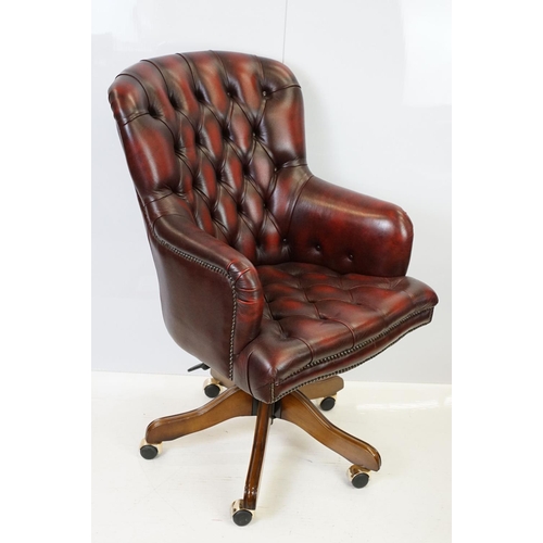 519 - Red leather adjustable height captain's chair, with button back, 107cm high x 60cm wide x 70cm deep ... 