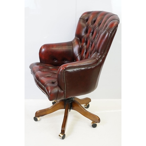 519 - Red leather adjustable height captain's chair, with button back, 107cm high x 60cm wide x 70cm deep ... 