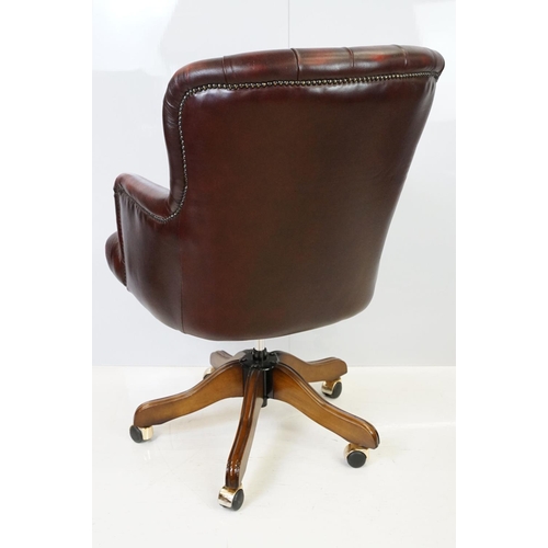 519 - Red leather adjustable height captain's chair, with button back, 107cm high x 60cm wide x 70cm deep ... 