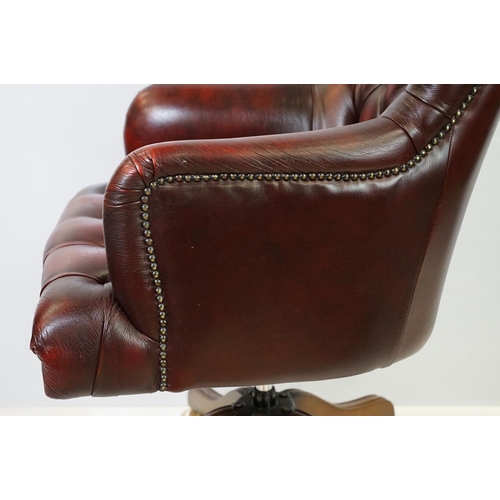 519 - Red leather adjustable height captain's chair, with button back, 107cm high x 60cm wide x 70cm deep ... 