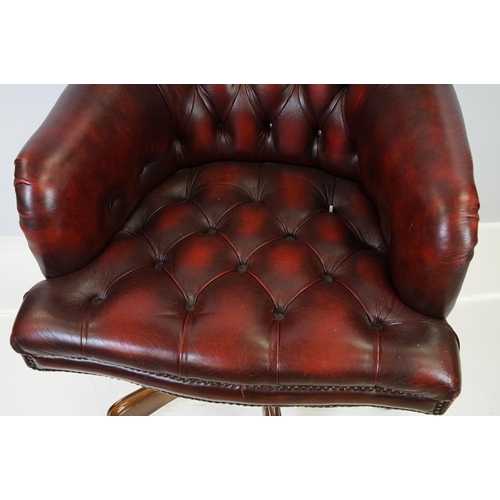 519 - Red leather adjustable height captain's chair, with button back, 107cm high x 60cm wide x 70cm deep ... 