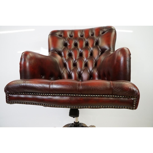 519 - Red leather adjustable height captain's chair, with button back, 107cm high x 60cm wide x 70cm deep ... 