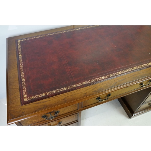 530 - Oak twin pedestal desk, with red leather inset top and an arrangement of nine drawers, with key, 79c... 