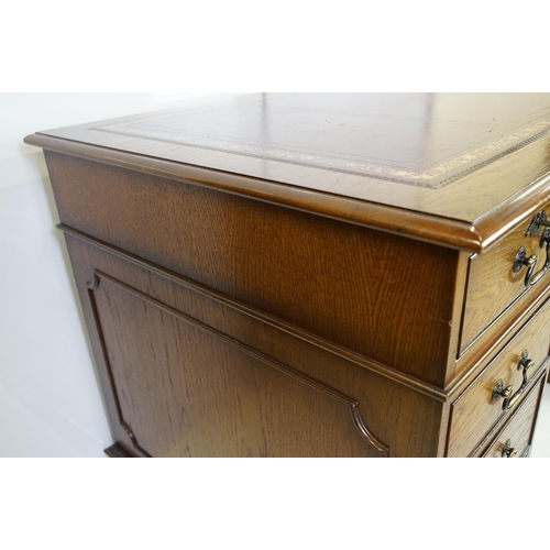 530 - Oak twin pedestal desk, with red leather inset top and an arrangement of nine drawers, with key, 79c... 