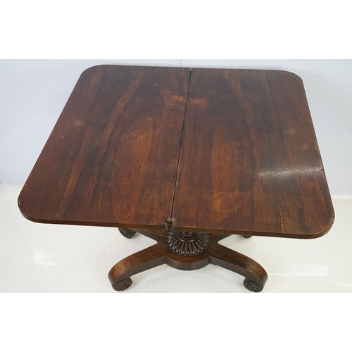 541 - William IV rosewood games table, top swivels to reveal enclosure,  on turned fluted support and four... 