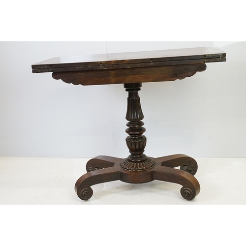 541 - William IV rosewood games table, top swivels to reveal enclosure,  on turned fluted support and four... 