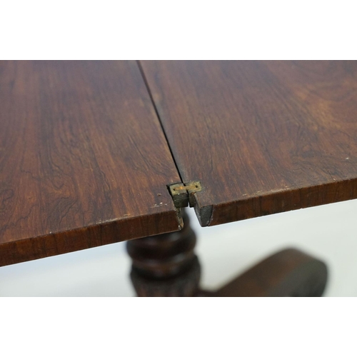 541 - William IV rosewood games table, top swivels to reveal enclosure,  on turned fluted support and four... 