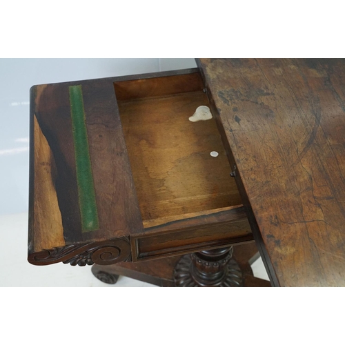 541 - William IV rosewood games table, top swivels to reveal enclosure,  on turned fluted support and four... 